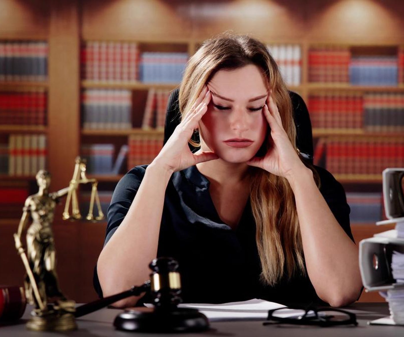 Overwhelmed lawyer buried in separate tools and paperwork